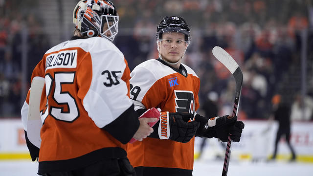 Philadelphia Flyers' Matvei Michkov and Aleksei Kolosov talk on the ice during the first period of an NHL hockey game against the Montreal Canadiens 