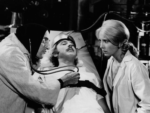 Marty Feldman listens to Gene Wilder's heart as Teri Garr looks on in a scene from 1974's "Young Frankenstein."