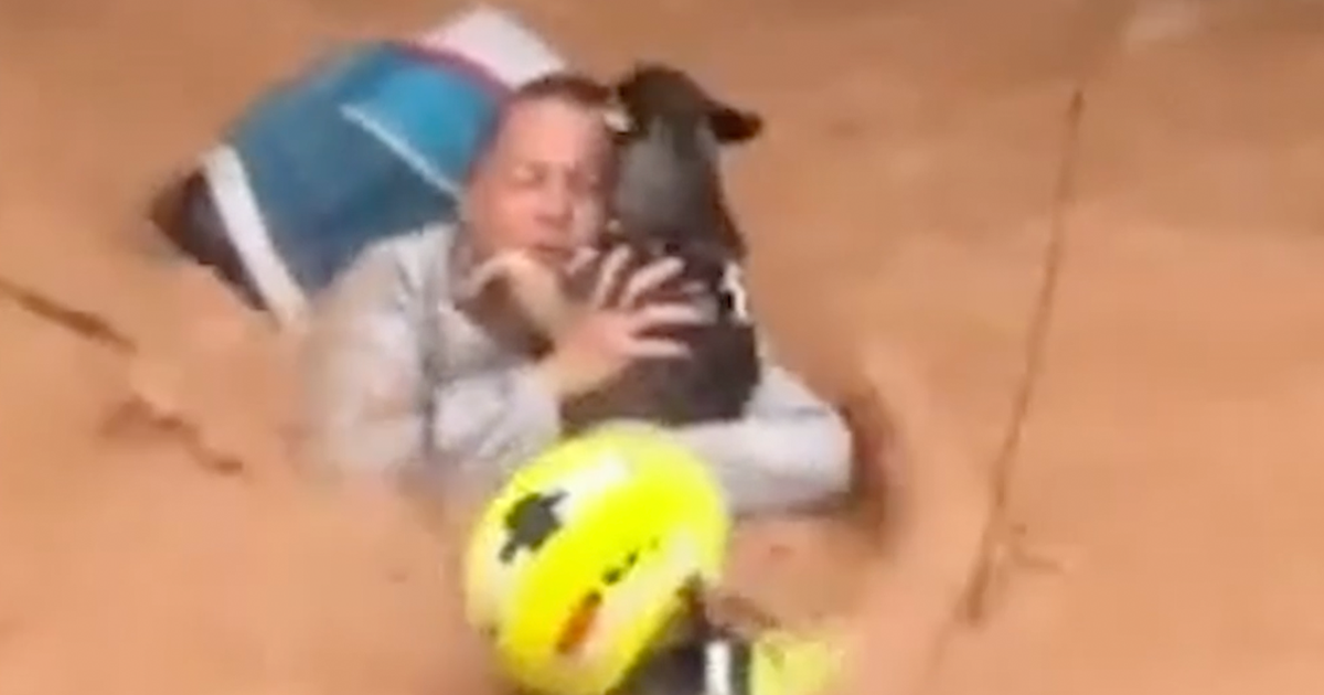 Woman and her dog rescued from waist-high flooding in Spain - CBS News