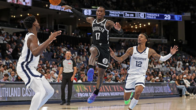 Dennis Schroder #17 of the Brooklyn Nets passes the ball against Ja Morant #12 of the Memphis Grizzlies during the first half at FedExForum on October 30, 2024 in Memphis, Tennessee. 