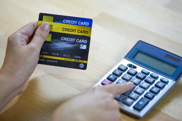 woman calculate how much cost or spending have with credit cards 