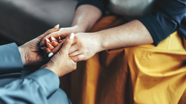 Two women sitting in armchairs and talking. Woman psychologist talking to patient