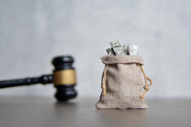 Closeup image bag of money and judge gavel. 