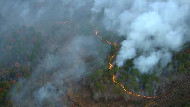 A line of fire and smoke are seen from overhead 