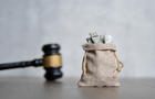 Closeup image bag of money and judge gavel. 