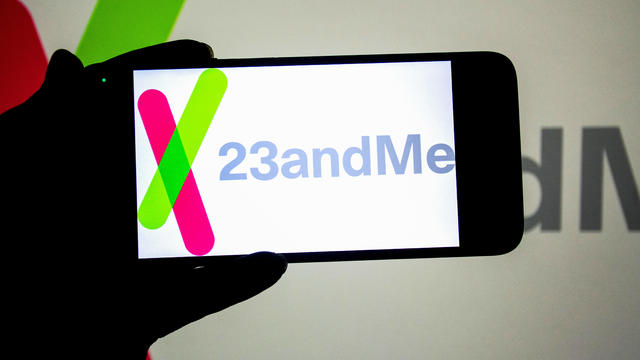 In this photo illustration, a 23andMe logo seen displayed on 