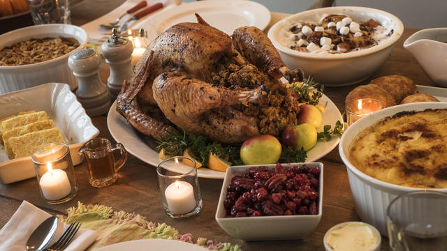 Dining table filled with thanksgiving food 