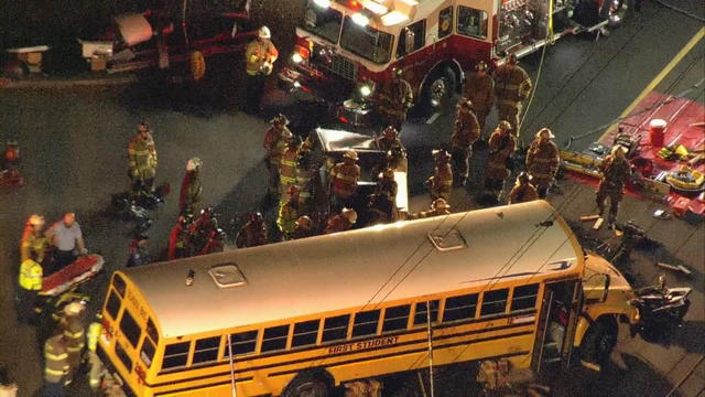 Emergency crews surround a school bus at an accident scene 