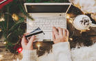 Woman using credit card to shop online, close up 