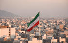 Iranian flag waving with city skyline on background in Tehran, Iran 