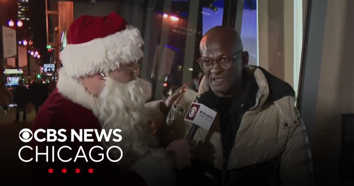 Santa Claus talks to a recipient of The Salvation Army services