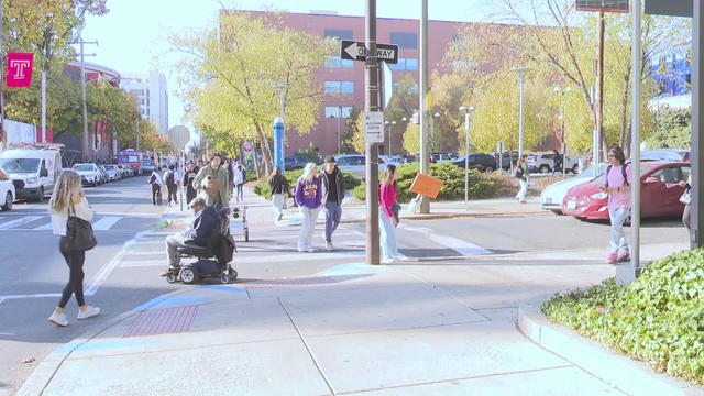 A photo of people walking on Temple University's campus 