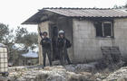 Israeli soldiers are stationed next to a house that was 