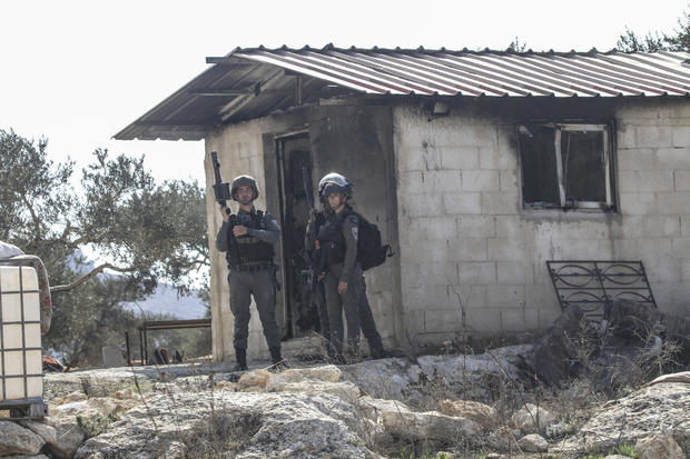 Israeli soldiers are stationed next to a house that was 