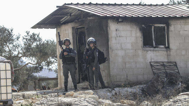 Israeli soldiers are stationed next to a house that was 