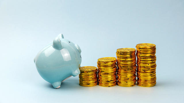 Piggy Bank Climbing Stack Of Coins 