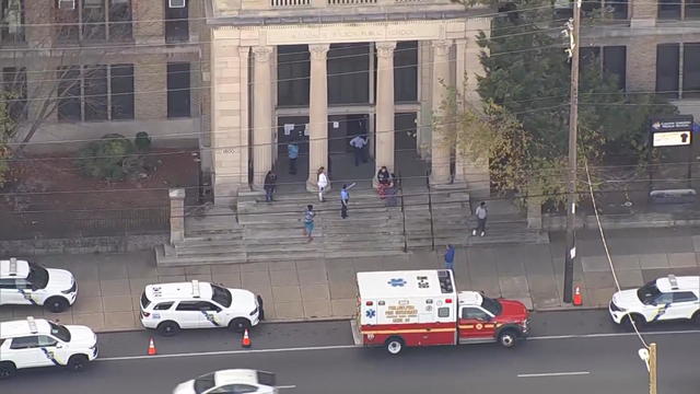 Police cars and an ambulance are seen outside of Castor Gardens Middle School in Philadelphia 