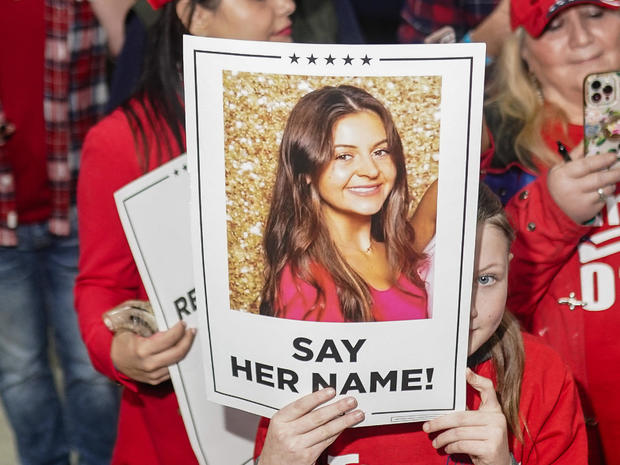 Trump supporters hold photos of Laken Riley 