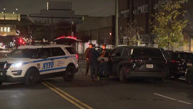 An NYPD vehicle and a van stopped on a Brooklyn street. 