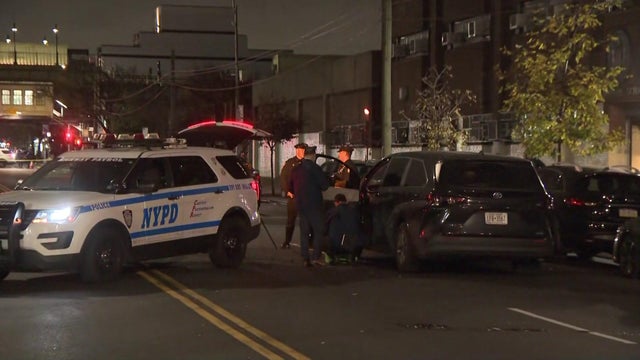 An NYPD vehicle and a van stopped on a Brooklyn street.