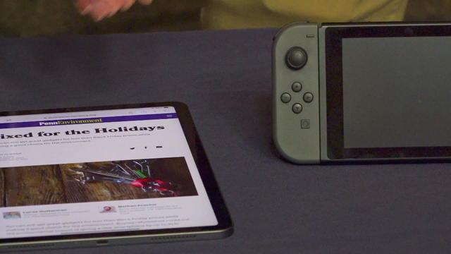 A report called Fixed for the Holidays is shown next to a handheld gaming device 