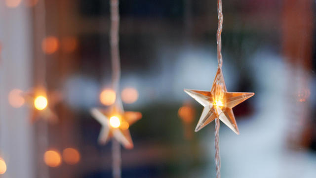 star shaped christmas lights in a window 