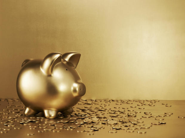 Gold piggy bank with gold coins 