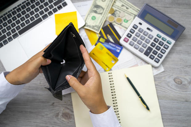 poor Asian woman hand open empty purse looking for money having problem bankrupt broke after credit card payday 