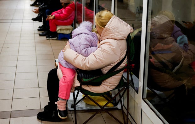 People take shelter inside a metro station during a Russian military attack, in Kyiv