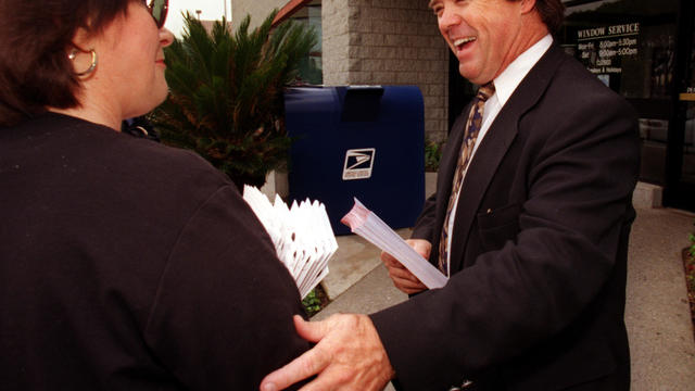 County Supervisor candidate Mike Morgan, right, talks to Judy Winters while stumping for votes at a 