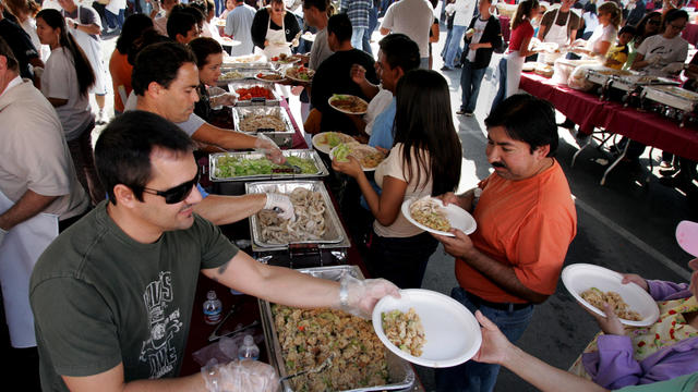 Left, Volunteer Mike Warren was serving up free Thanksgiving dinners. Frank Garcia, owner of La Cas 