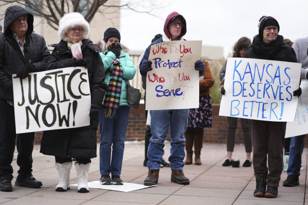 People listen to a speaker at a rally outside the federal courthouse on what was supposed to be the opening day for a trial for former police detective Roger Golubski, Dec. 2, 2024, in Topeka, Kansas. 