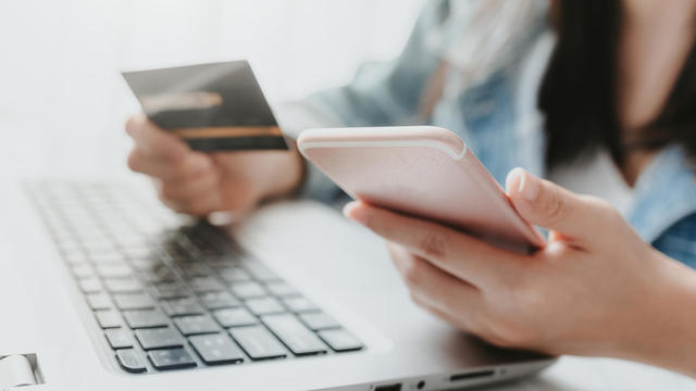 hands holding a credit card and using smart phone for online shopping 