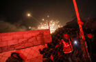 People run for cover as an explosion from an Israeli strike occurs near a makeshift camp for displaced Palestinians, in Mawasi Khan Yunis in the southern Gaza Strip on Dec. 4, 2024, amid the ongoing war between Israel and the Hamas militant group. 