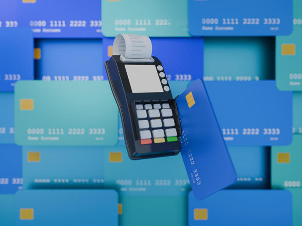 Credit card reader in use, background filled with credit cards, render 