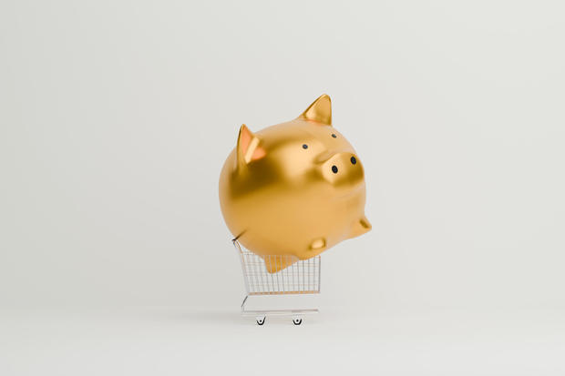 Golden Piggy bank on shopping cart 