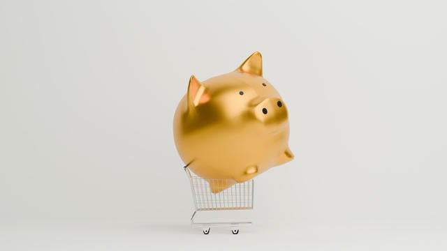 Golden Piggy bank on shopping cart 