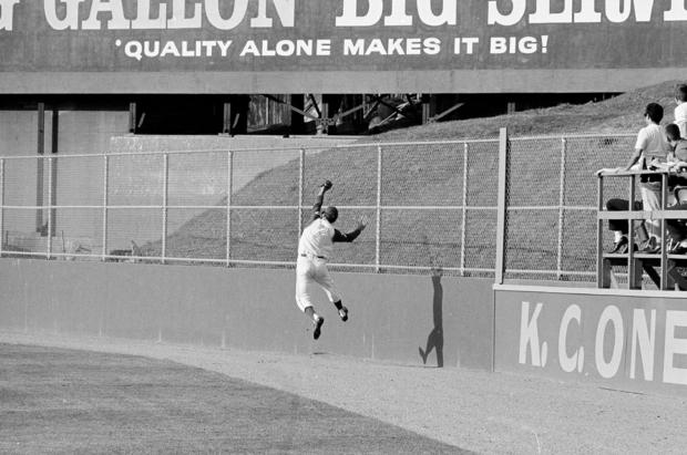 Kansas City's right fielder Rocky Colavito makes a running, leaping backhand catch of a fly ball by Minnesota's Bernie Allen in the eighth inning at Kansas City, on May 3, 1964. 