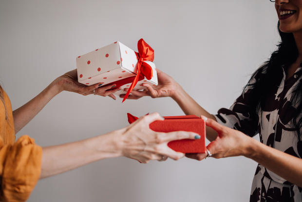 Anonymous Female Friends Exchanging Gifts 