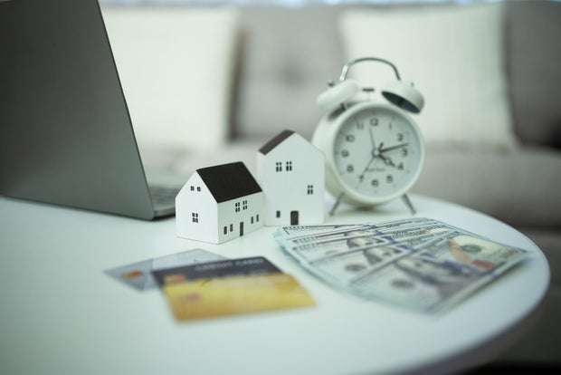 Concept of buying a house with credit card and cash 