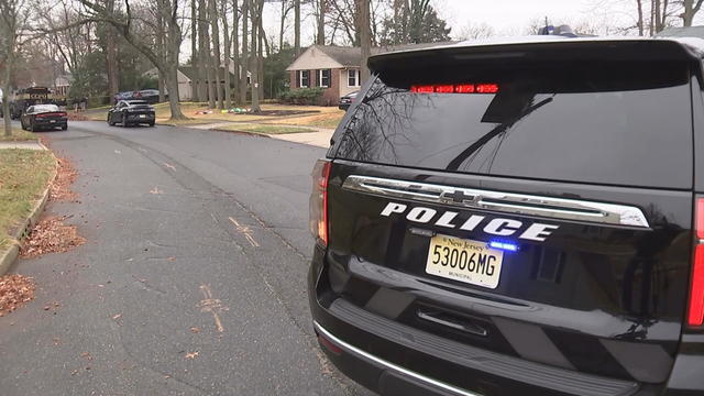 A police SUV is seen on the residential street where veterinarian Michael Anthony was found dead 