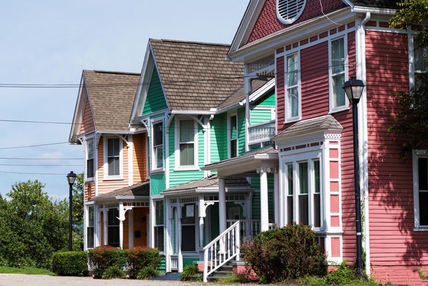 Rows of brightly colored wood-frame houses on a summer day