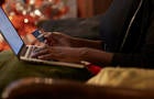 Young woman ordering Christmas gifts online 