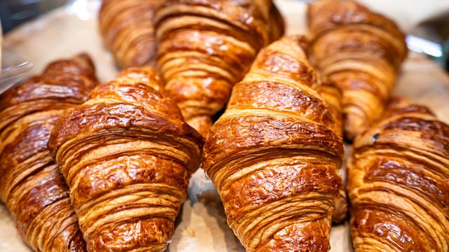 Close up of tray of freshly baked croissants in a bakery 