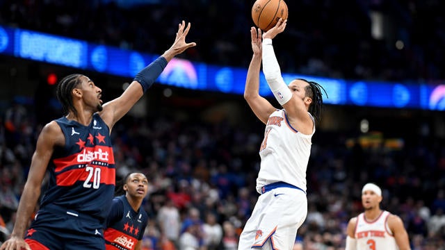 Jalen Brunson #11 of the New York Knicks shoots the ball in overtime against Alexandre Sarr #20 of the Washington Wizards at Capital One Arena on December 28, 2024 in Washington, DC. 