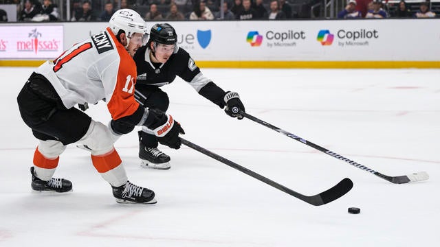 Philadelphia Flyers right wing Travis Konecny and Los Angeles Kings defenseman Jordan Spence vie for the puck during the first period of an NHL hockey game 