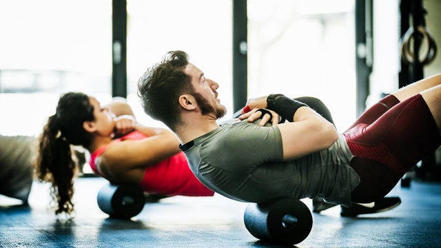 Gym Goers Performing Floor Exercises Together
