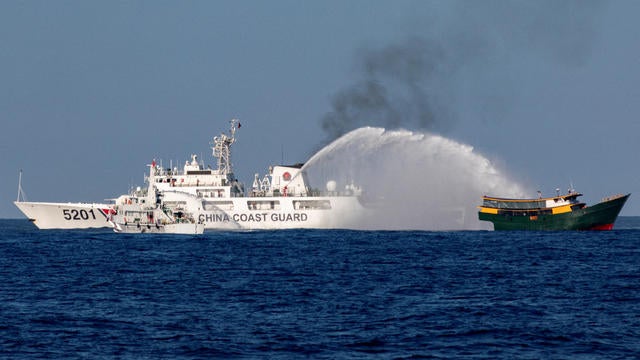 FILE PHOTO: Chinese Coast Guard vessels fire water cannons towards a Philippine resupply vessel Unaizah May 4 on its way to a resupply mission at Second Thomas Shoal in the South China Sea 