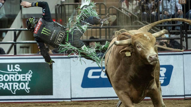 Derek Kolbaba of Walla Walla, Washington rides a bull during 