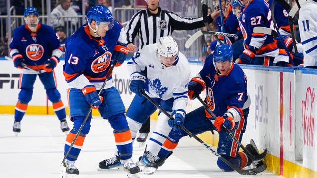 Mathew Barzal #13 and Maxim Tsyplakov #7 of the New York Islanders battles for the puck with Bobby McMann #74 of the Toronto Maple Leafs during the third period at UBS Arena on January 02, 2025 in Elmont, New York. 